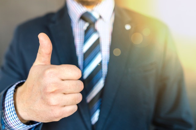 close-up-photo-of-man-wearing-black-suit-jacket-doing-thumbs-684385