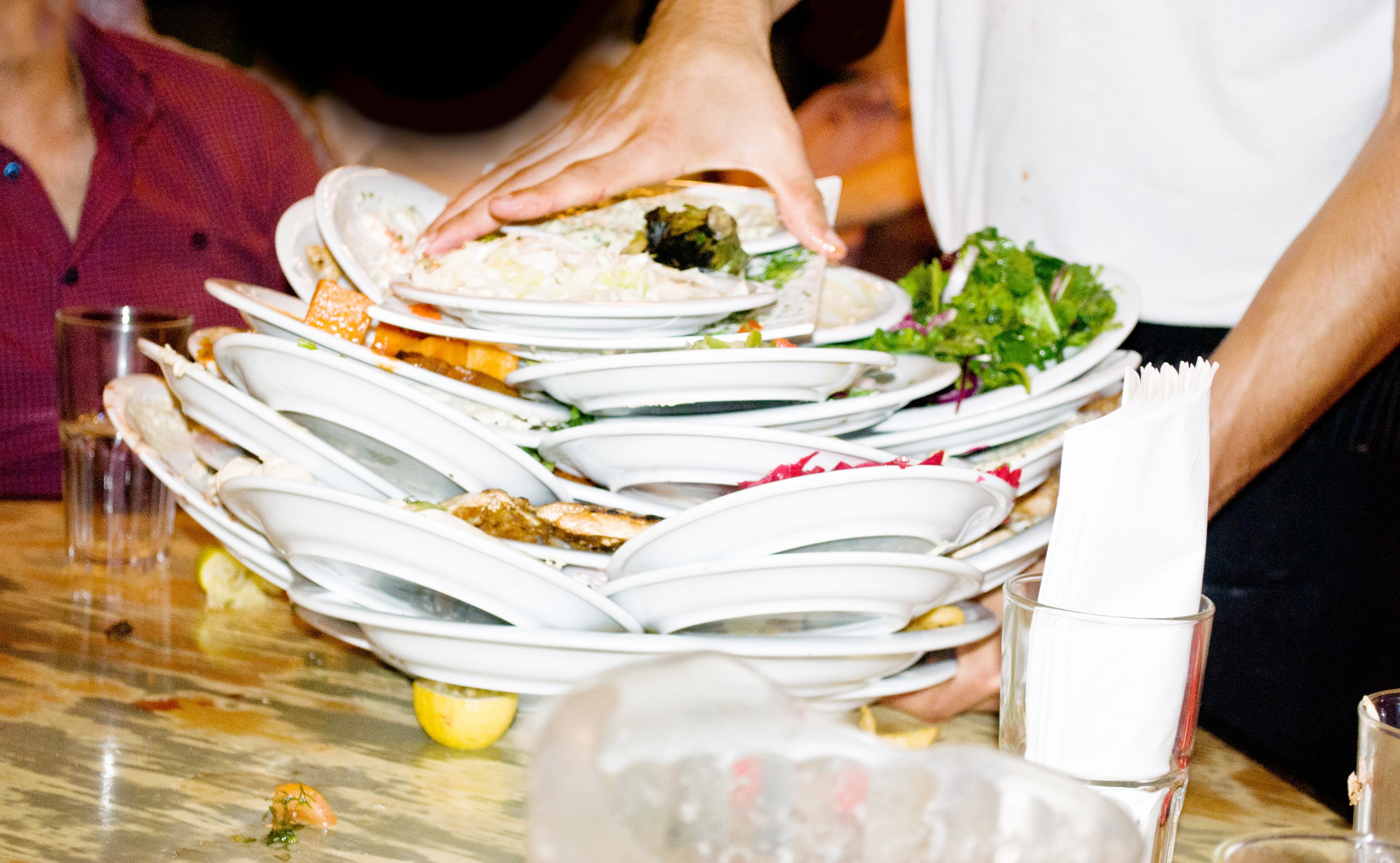 Waiter piles dishes on half-eaten food instead of learning how to reduce waste in the kitchen